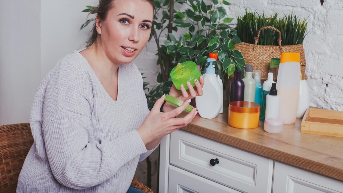 a woman holding a green pepper