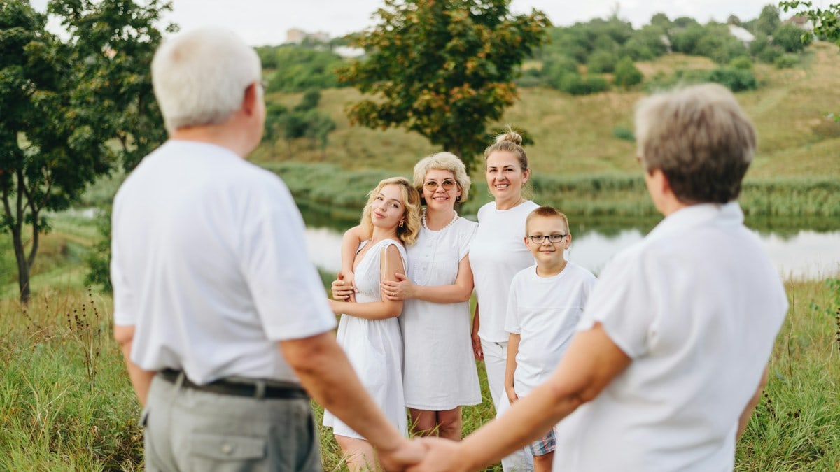 a group of people standing in a field